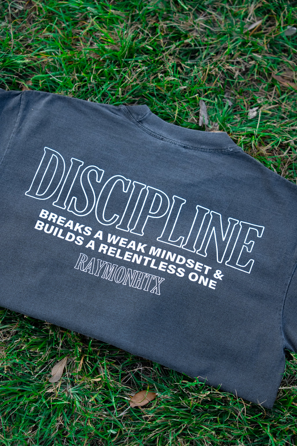 Dark gray t-shirt with motivational quote.